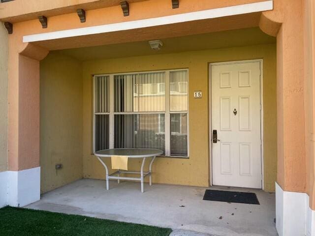 doorway to property with stucco siding