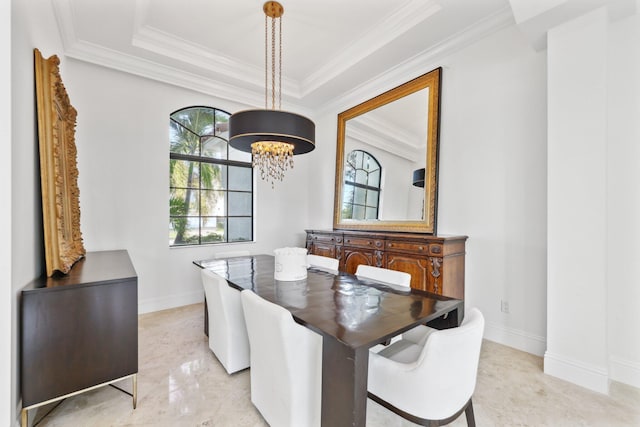 dining area with an inviting chandelier, a tray ceiling, crown molding, and baseboards