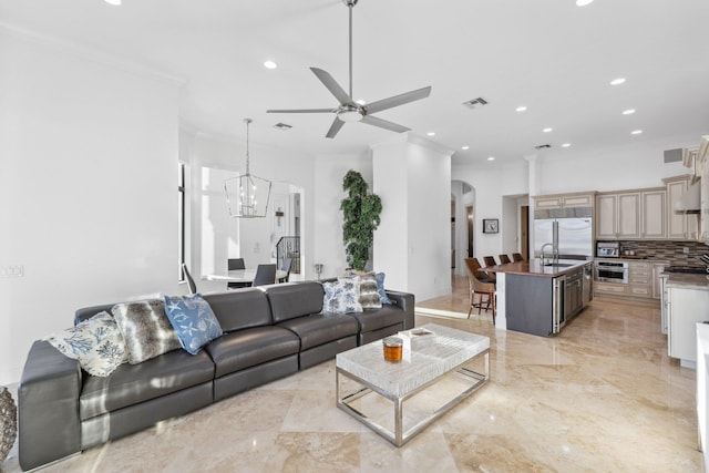 living area with crown molding, visible vents, arched walkways, and marble finish floor