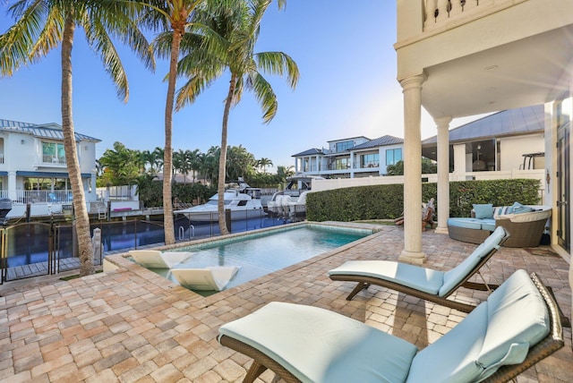 view of swimming pool featuring a patio area, a fenced in pool, and outdoor lounge area