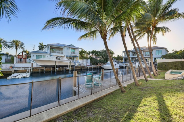 view of pool with a residential view, a water view, a lawn, and a boat dock