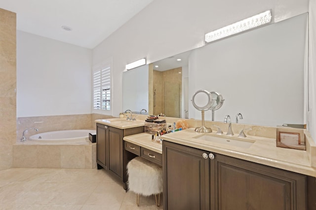 bathroom featuring a sink, a garden tub, two vanities, and tile patterned flooring