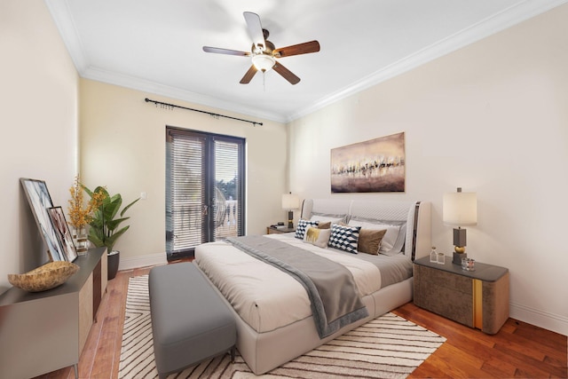 bedroom featuring a ceiling fan, crown molding, wood finished floors, and baseboards