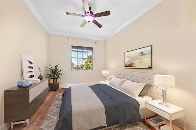 bedroom featuring a ceiling fan, crown molding, baseboards, and wood finished floors