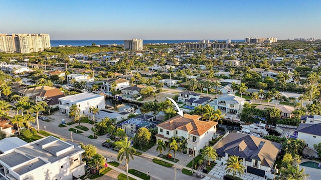 birds eye view of property with a water view and a city view