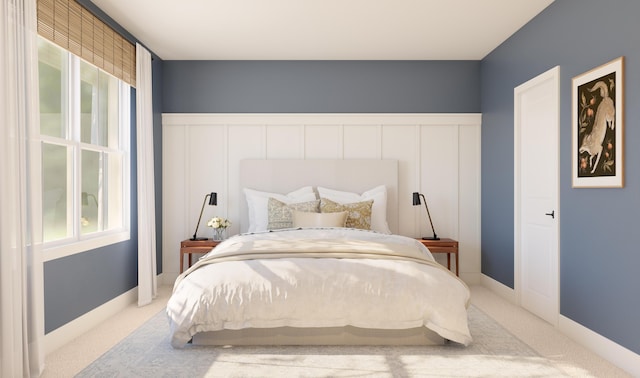 carpeted bedroom featuring a wainscoted wall and a decorative wall