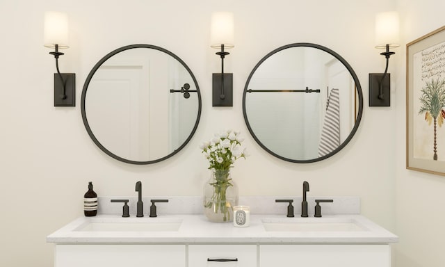 bathroom featuring a sink and double vanity