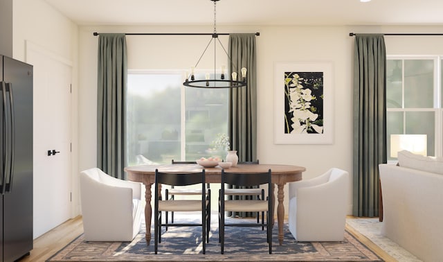 dining space with a notable chandelier and wood finished floors