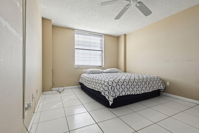 bedroom featuring a ceiling fan, baseboards, and a textured ceiling