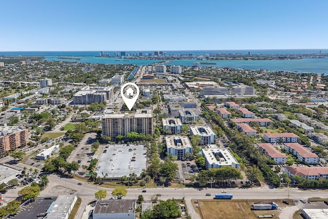 drone / aerial view featuring a water view and a view of city