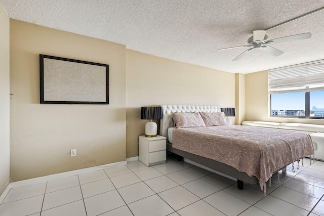 bedroom featuring light tile patterned floors, a textured ceiling, and ceiling fan