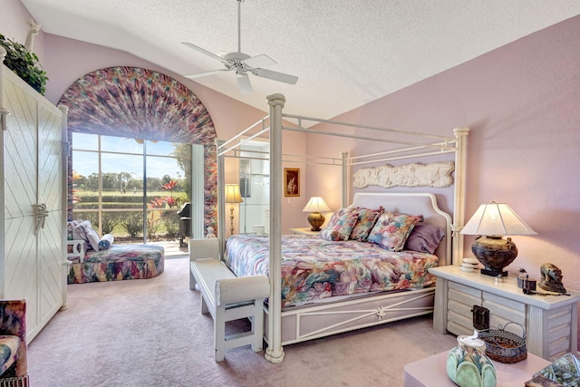 bedroom featuring a ceiling fan, carpet, lofted ceiling, and a textured ceiling