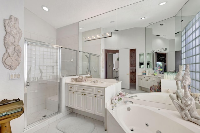 bathroom featuring lofted ceiling, a jetted tub, a shower stall, and vanity