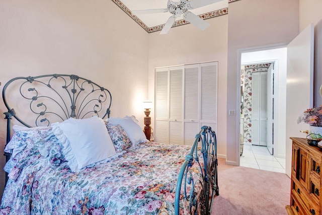 bedroom with baseboards, ceiling fan, tile patterned floors, carpet floors, and a closet