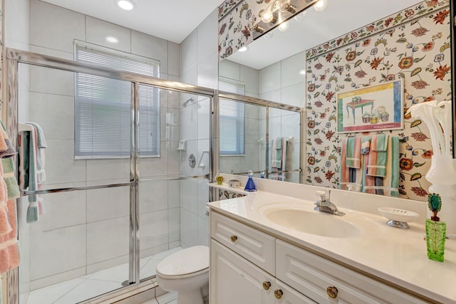 bathroom featuring a stall shower, vanity, and toilet