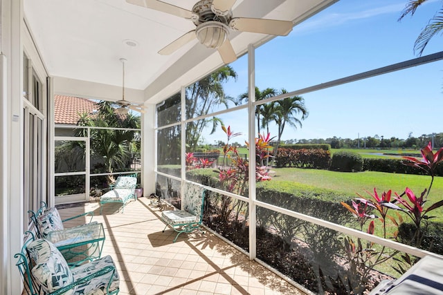 sunroom / solarium featuring ceiling fan