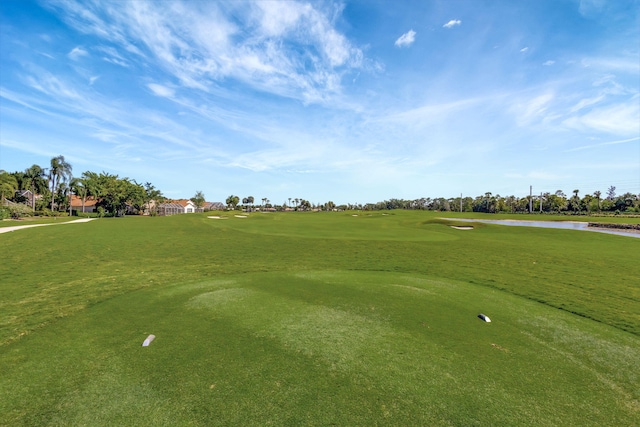 surrounding community with a water view and golf course view