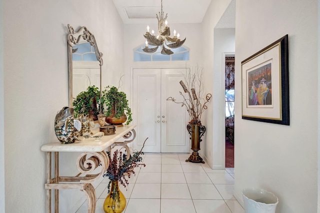 entrance foyer featuring light tile patterned floors, french doors, and a notable chandelier