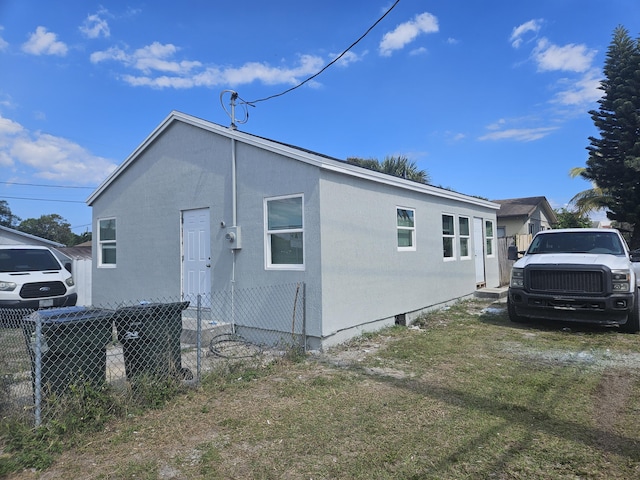 view of property exterior featuring cooling unit and fence