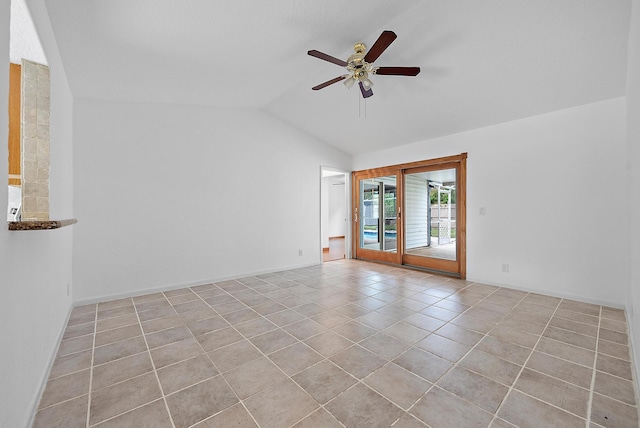 unfurnished room with lofted ceiling, ceiling fan, light tile patterned floors, and baseboards