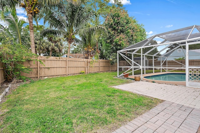 view of yard with glass enclosure, a fenced backyard, a fenced in pool, and a patio