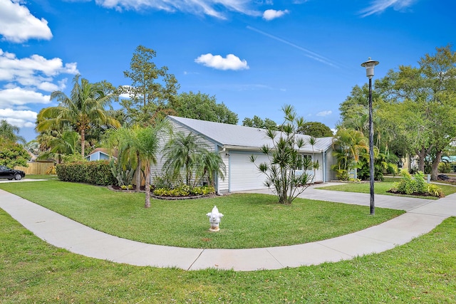 view of front of house with a garage, driveway, and a front yard