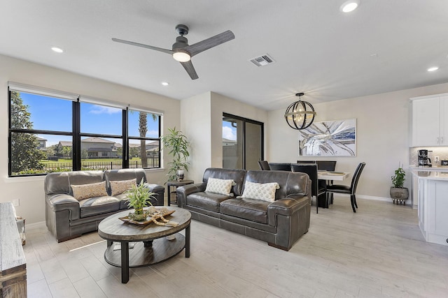 living room with recessed lighting, baseboards, visible vents, and light wood-type flooring