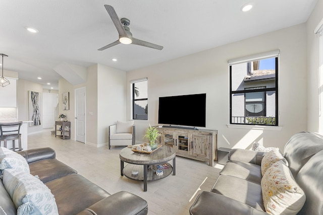 living room with recessed lighting, baseboards, light wood-style flooring, and ceiling fan