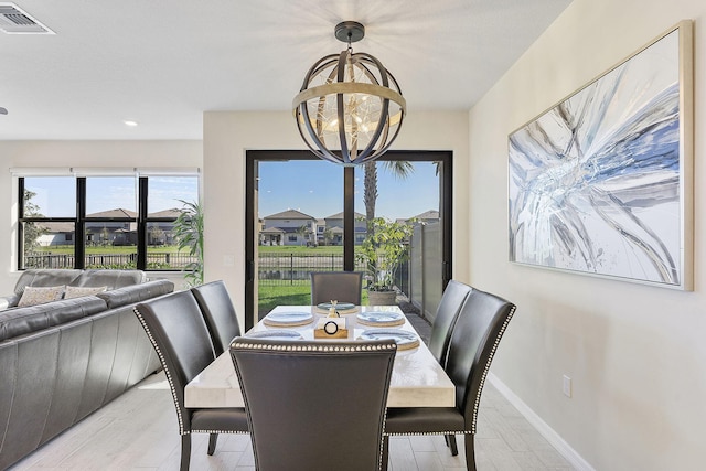 dining room with visible vents, baseboards, and an inviting chandelier