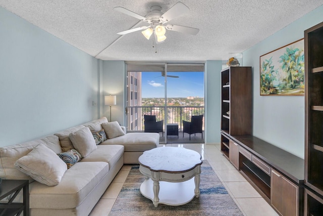 living room featuring a wall of windows, a textured ceiling, ceiling fan, and light tile patterned floors