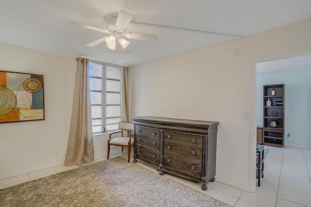 bedroom with tile patterned flooring, a textured ceiling, and ceiling fan