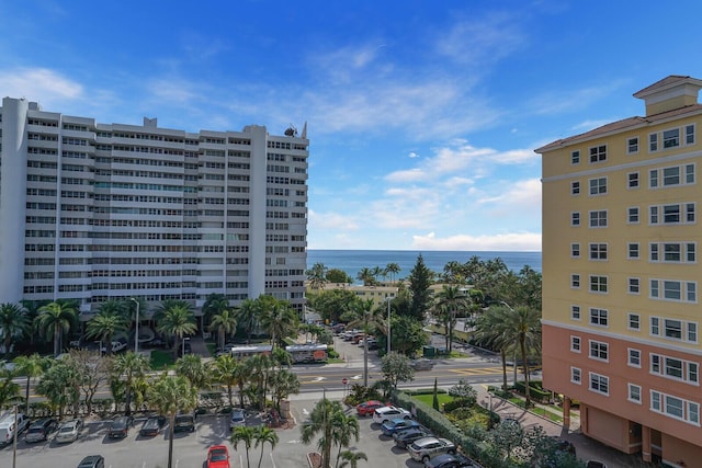 view of property featuring uncovered parking and a water view