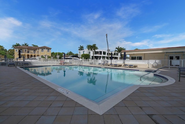 community pool featuring a patio and fence