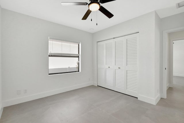 unfurnished bedroom featuring visible vents, baseboards, ceiling fan, and a closet