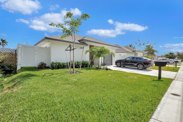 view of front facade featuring driveway, a garage, a front lawn, and stucco siding