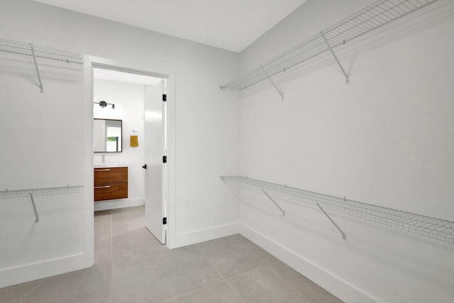 walk in closet with light tile patterned flooring