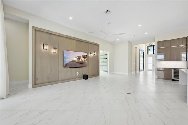 unfurnished living room featuring recessed lighting, beverage cooler, visible vents, and marble finish floor