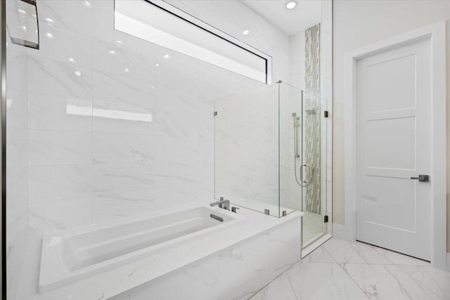 bathroom with a stall shower, marble finish floor, and a bath