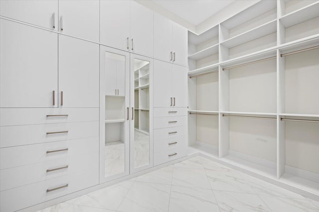 spacious closet featuring marble finish floor