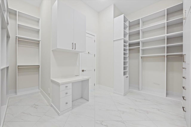 spacious closet with marble finish floor