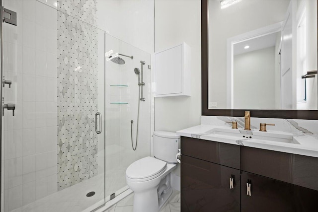 full bath featuring a stall shower, vanity, and toilet