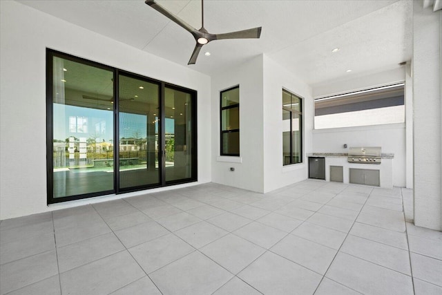 view of patio / terrace featuring exterior kitchen, ceiling fan, and area for grilling