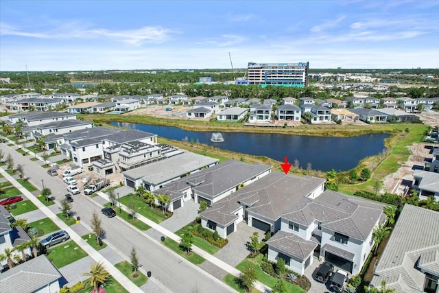 drone / aerial view with a water view and a residential view