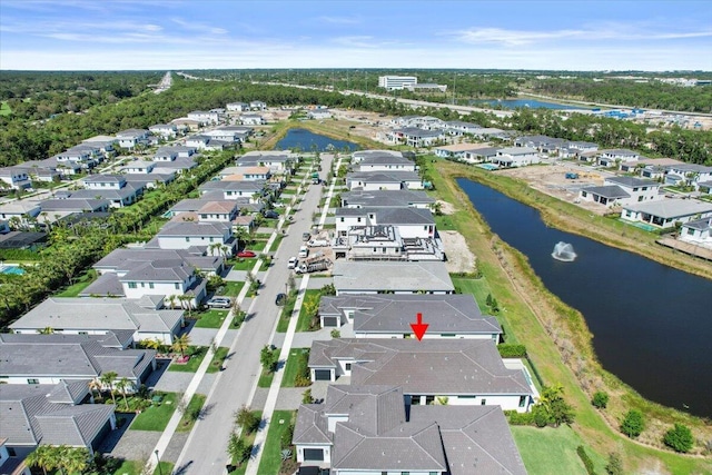 drone / aerial view with a residential view and a water view