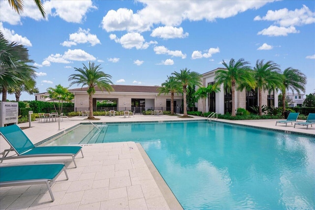 pool with fence and a patio