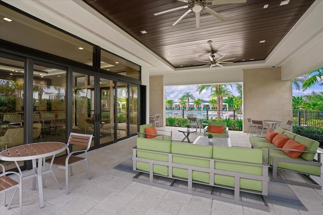 view of patio / terrace with fence, an outdoor living space, a ceiling fan, and french doors