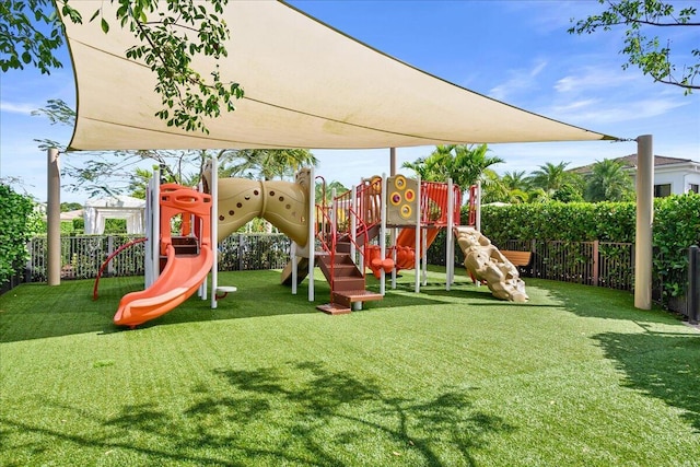 communal playground with a yard and fence