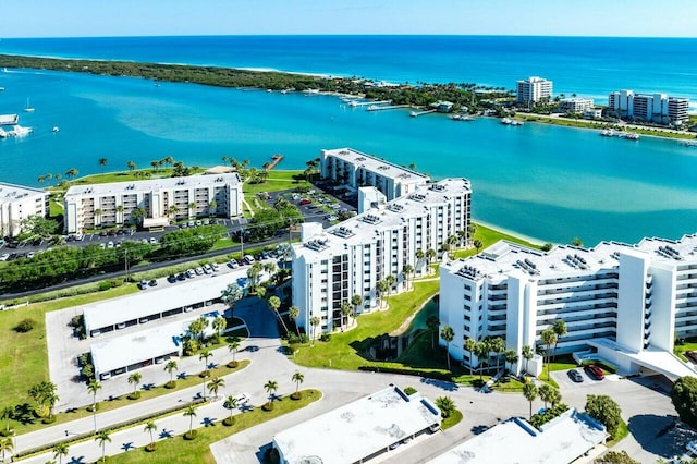 birds eye view of property with a city view and a water view