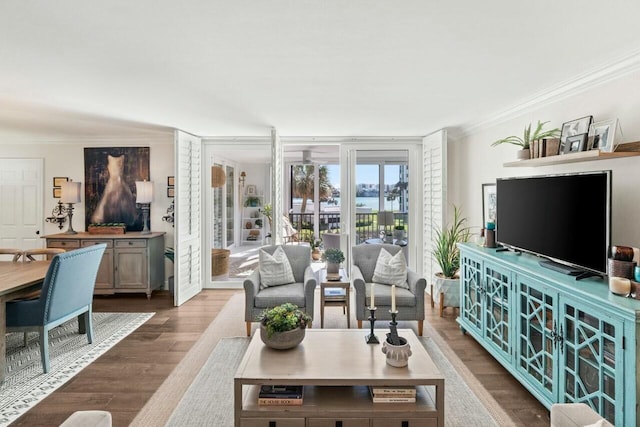 living area with crown molding and wood finished floors