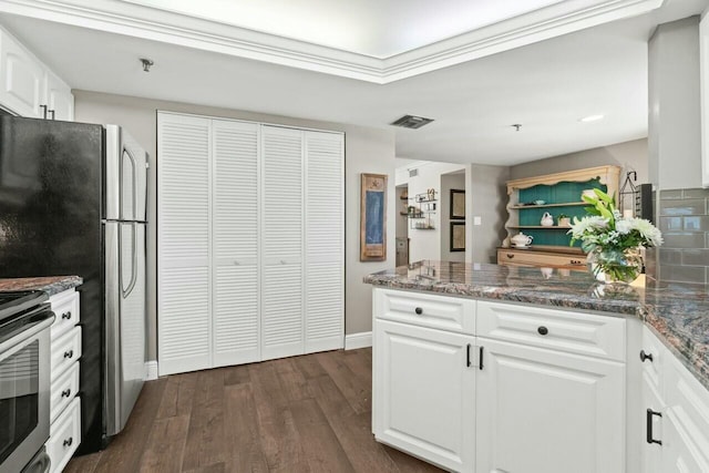 kitchen with dark stone countertops, dark wood-style floors, open shelves, appliances with stainless steel finishes, and white cabinetry